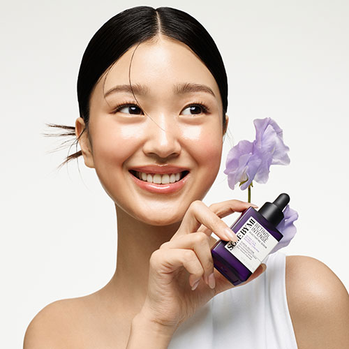 Korean anti-aging serums with retinol and peptides placed elegantly on vanity