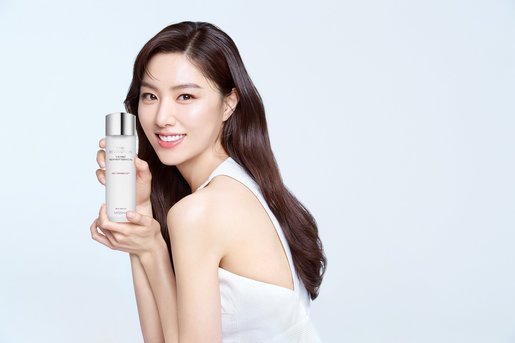 Applying toner and essence in a calm evening setting with soft ambient light